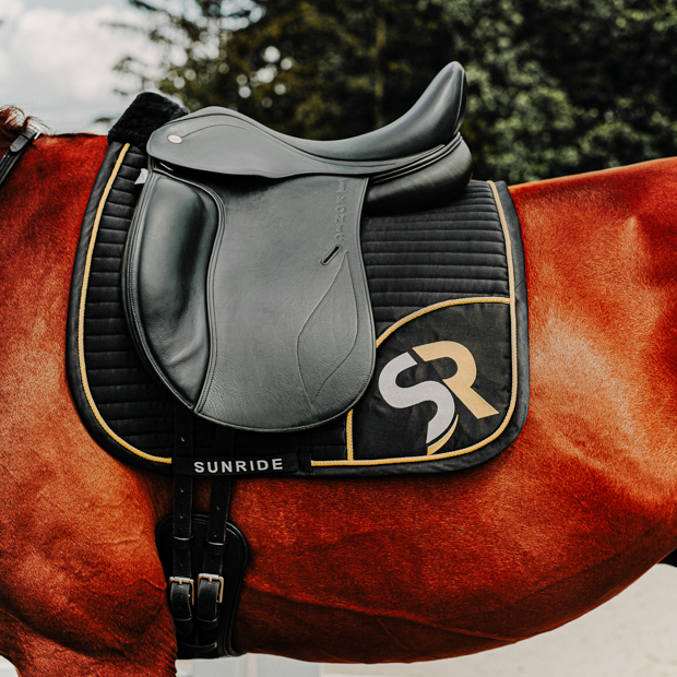 dressage saddle pad gold black breathable with fur on horse breathable dressage saddle pad gold and black exclusive line with fur on withers under saddle on a horse
