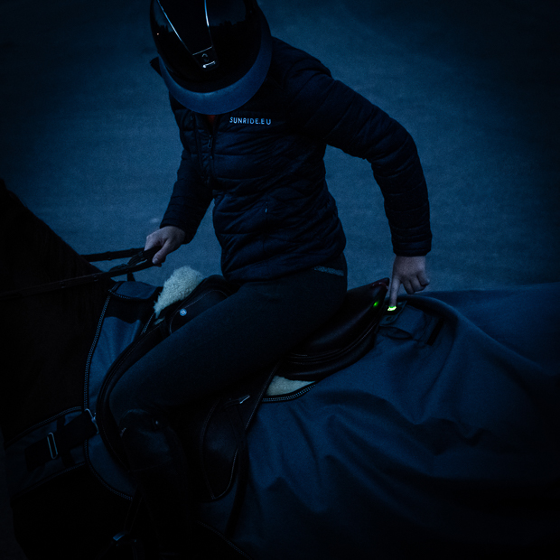 rider in the dark operating the grey led workout rug new york with white and red led lights turned on