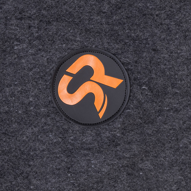 detailed view of sr logo of grey wool heating rug st. moritz with three levels of heating and program
