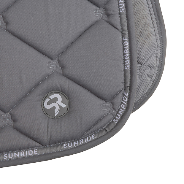 detailed view of sr quilting and logo on grey wellington line jumping saddle pad with breathable air mesh spine by sunride