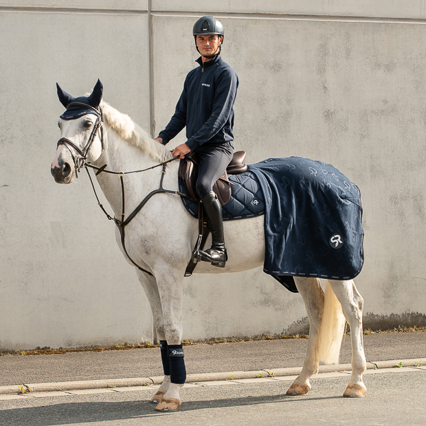 wellington set blue with matching cooler rug, ear net, saddle pad and bandages by sunride on a horse with rider