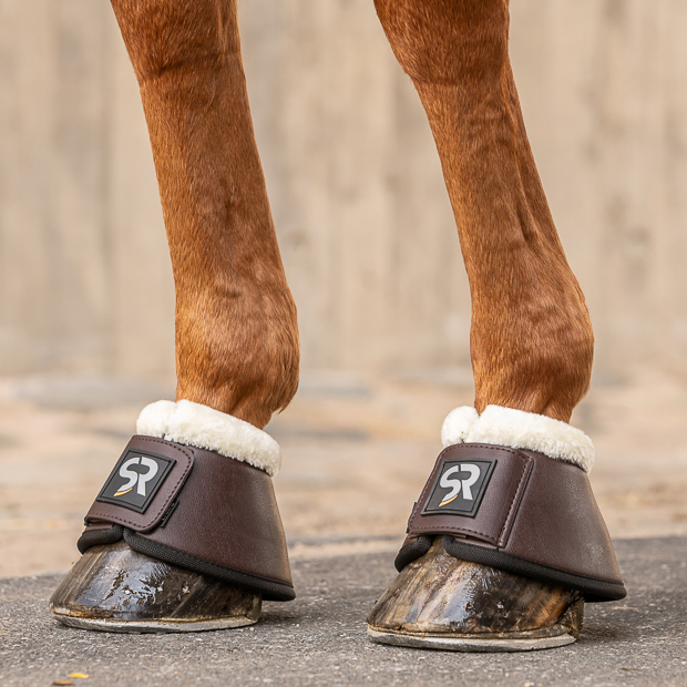 brown leather bell boots with fur and  neoprene inside and velcro closure on a horse