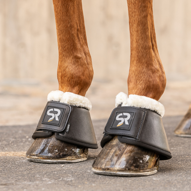 black leather bell boots with fur and  neoprene inside and velcro closure on a horse