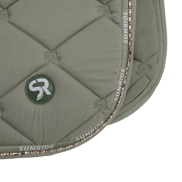 logo and gems of dressage saddle pad wellington olive with gemstones, breathable spine and padded withers detailed view of logo and gemstones on breathable dressage saddle pad wellington olive with gemstones and fur on withers