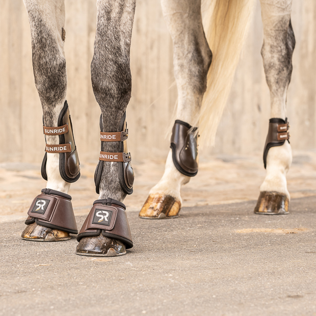 set of leather bell boots brown with neoprene inside and leather jumping boots brown with neoprene inside and elastic straps and safety net layer and fetlock boots with elastic straps by sunride