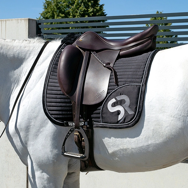 sr embroidery of breathable dressage saddle pad silver and black exclusive line with fur on withers under saddle on a horse