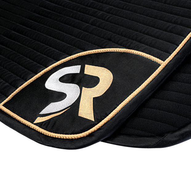 embroidery of dressage saddle pad gold black breathable with fur detailed view of embroidery on breathable dressage saddle pad gold and black exclusive line with fur on withers
