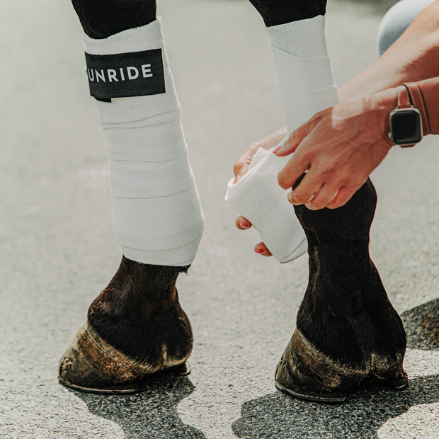 weisse bandagen mit reflektierender sunride aufschrift  im set am pferdebein