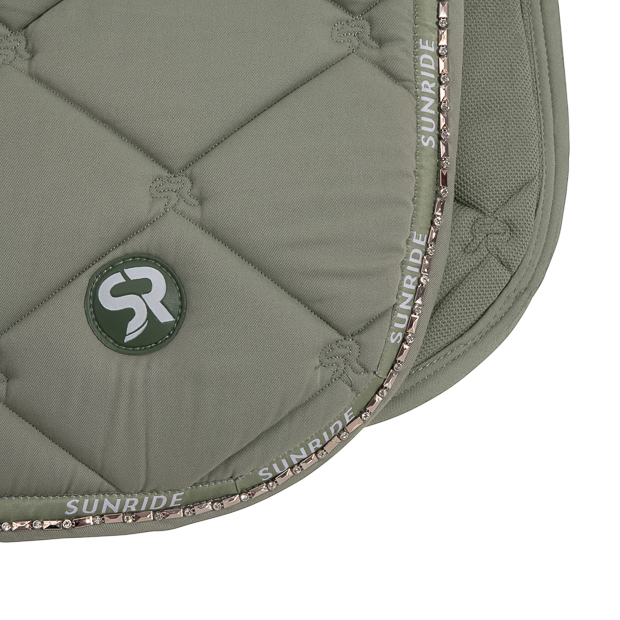 detailed view of logo and gemstones on breathable dressage saddle pad wellington olive with  gemstones and fur on withers
